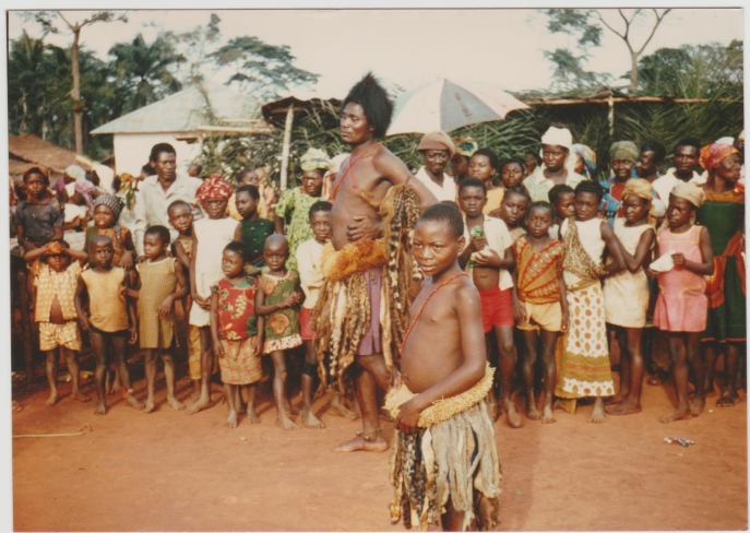 In the 1970s Mezing Merlin was the most powerful nganga (healer) on our road. He danced from sunset to dawn calling up the spirits to heal his clients. The young girl in front was his pupil; Merlin had to teach her how to control the djambe (witchcraft) in her belly so that she could become a powerful nganga in her turn. Credit: Peter Geschiere In the 1970s Mezing Merlin was the most powerful nganga (healer) on our road. He danced from sunset to dawn calling up the spirits to heal his clients. The young girl in front was his pupil; Merlin had to teach her how to control the djambe (witchcraft) in her belly so that she could become a powerful nganga in her turn. Credit: Peter Geschiere